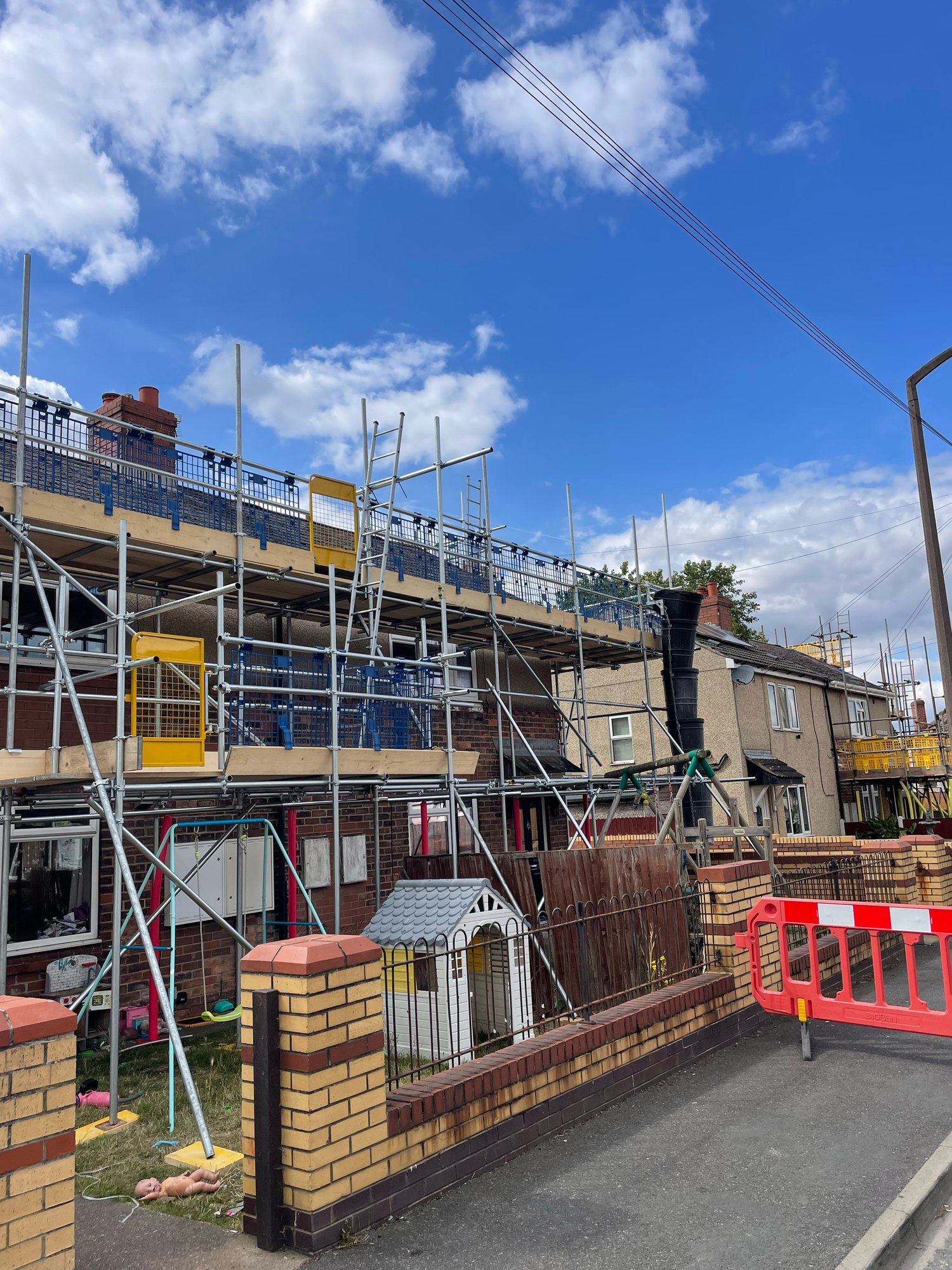 Front elevation residential scaffolding with debris chute on a Doncaster Council property for Wates Property Services